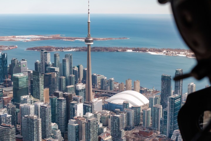 Aerial view of Toronto skyline with CN Tower and Lake Ontario, seen from a helicopter.