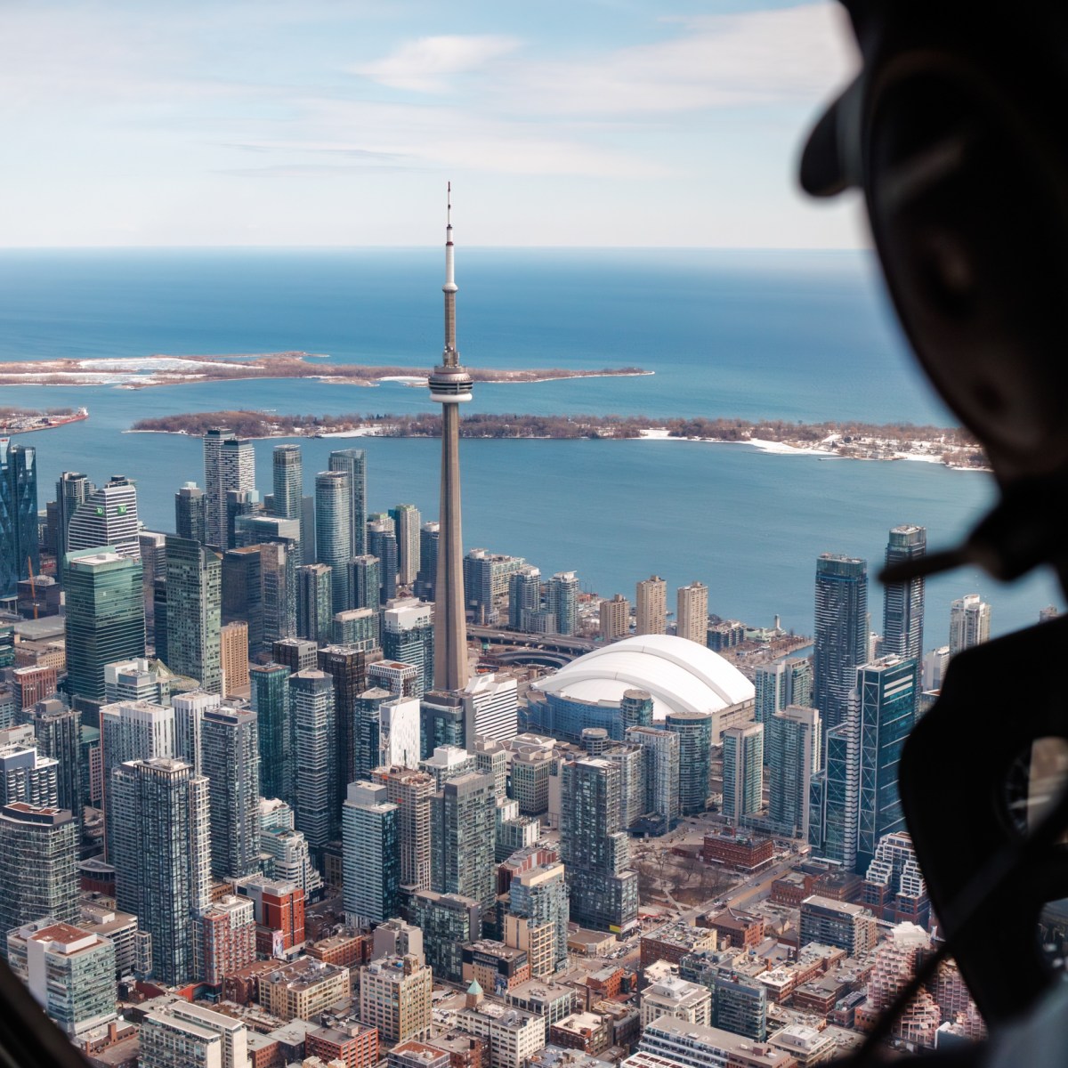 Aerial view of Toronto skyline with CN Tower and Lake Ontario, seen from a helicopter.